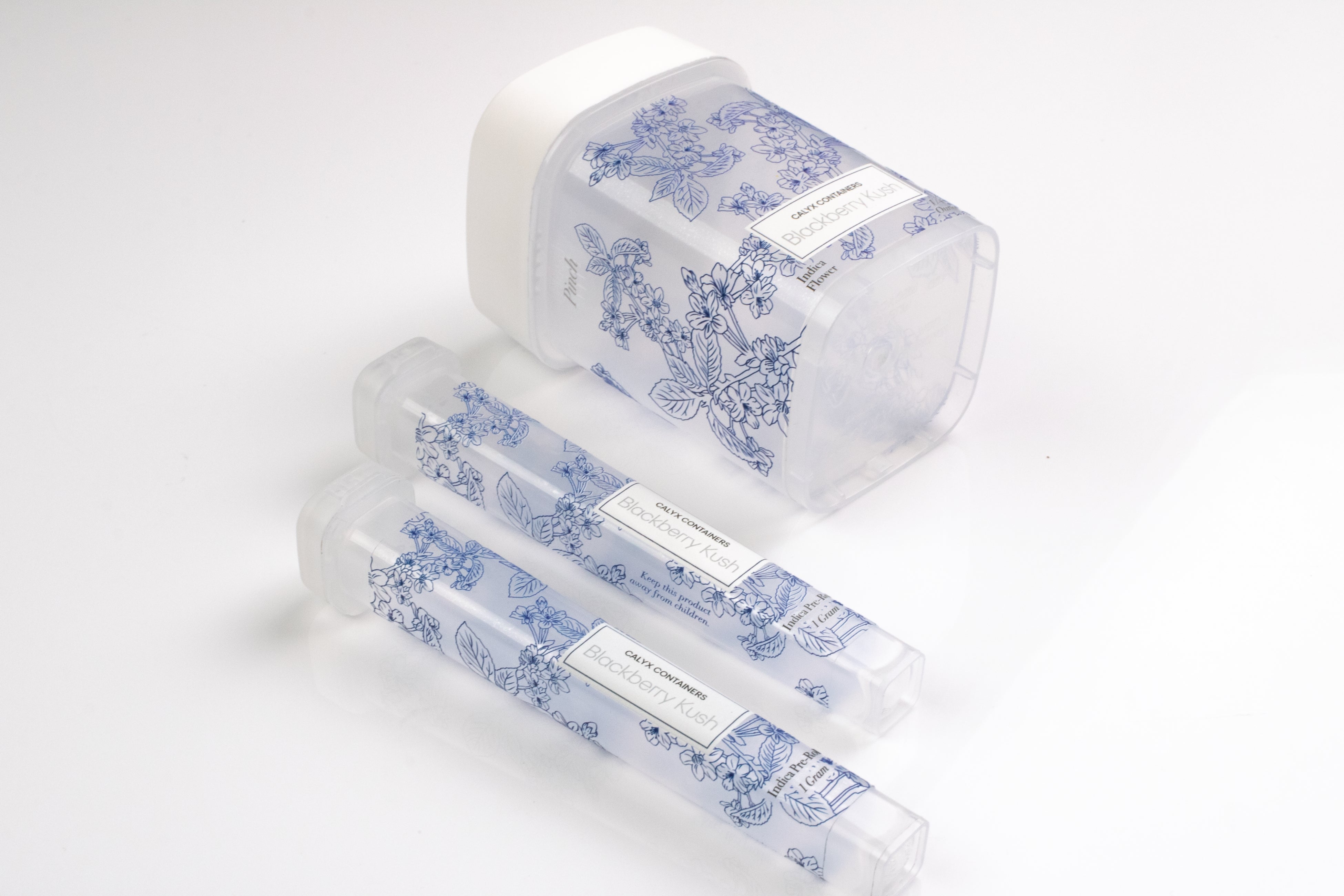 Two clear Joint Tubes and a clear ridged cannabis flower container with custom labels manufactured by Calyx Containers.