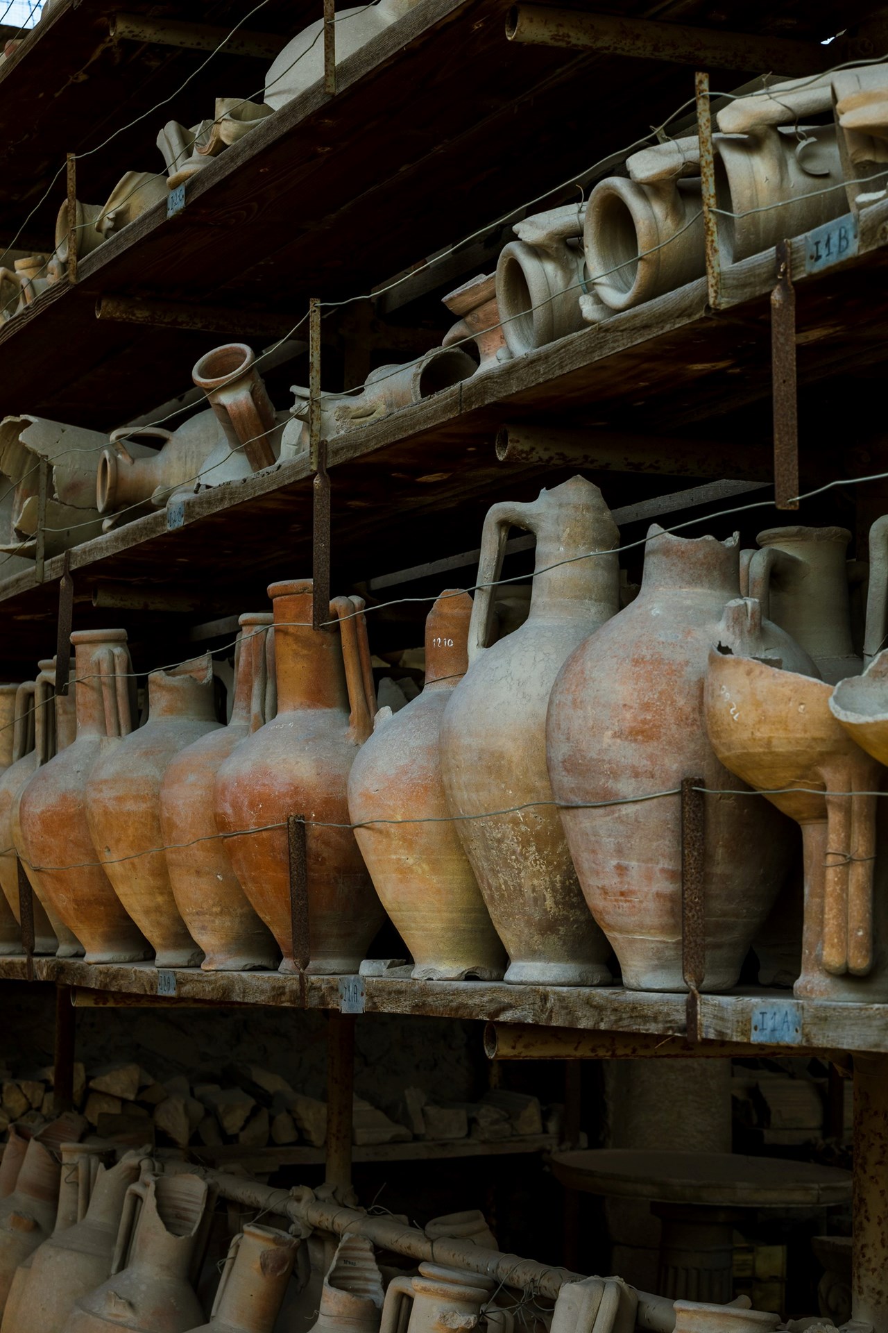 Collection of old terracotta pots on a shelf for restoration and display