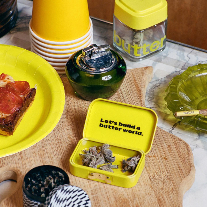 Food and cannabis on a table, with Calyx Jar featuring Butter custom branding and logo