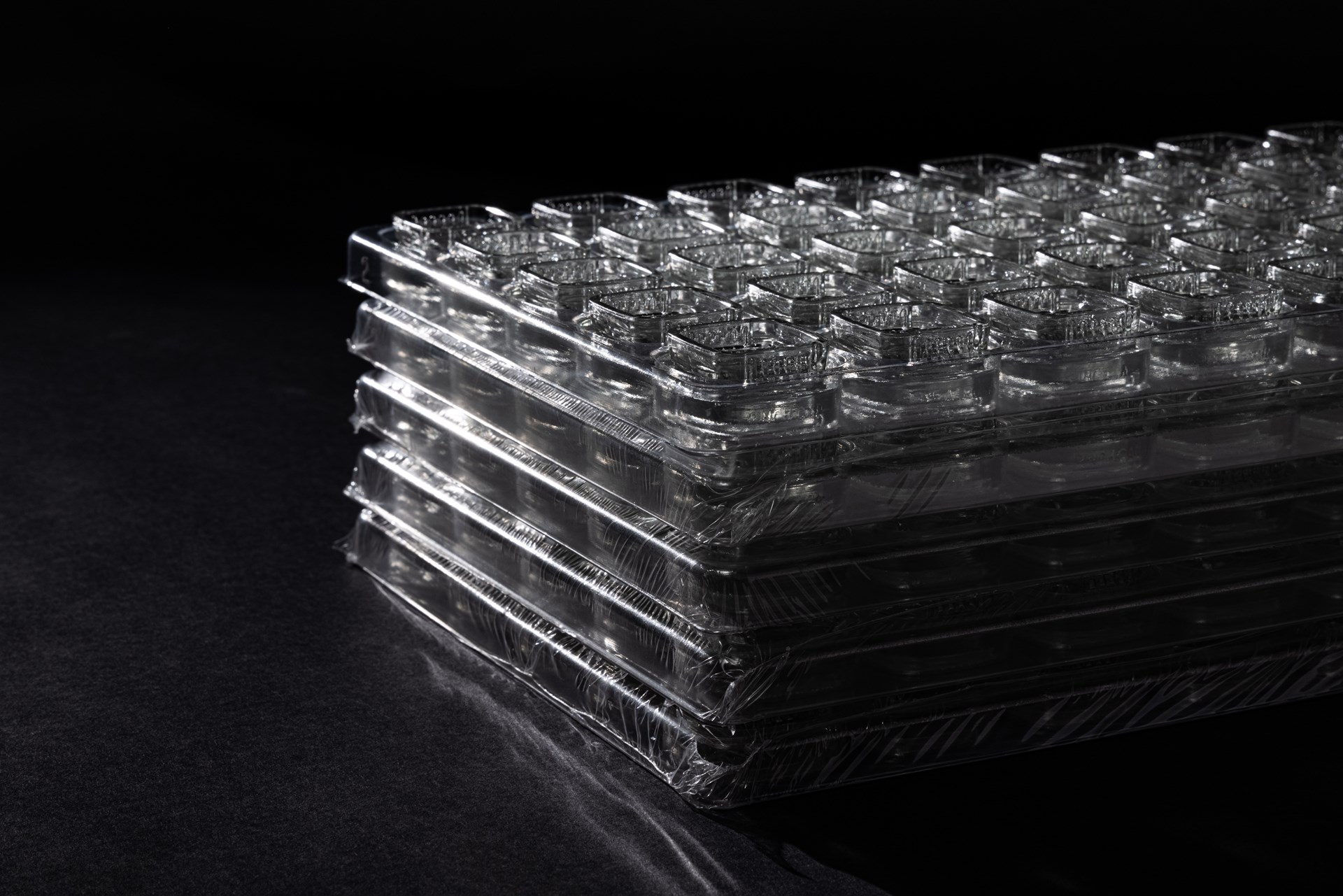Trays of saran-wrapped Calyx concentrate containers without lids